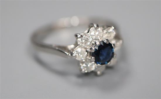 A modern 18ct white gold, sapphire and diamond cluster ring, size M, gross 3 grams.